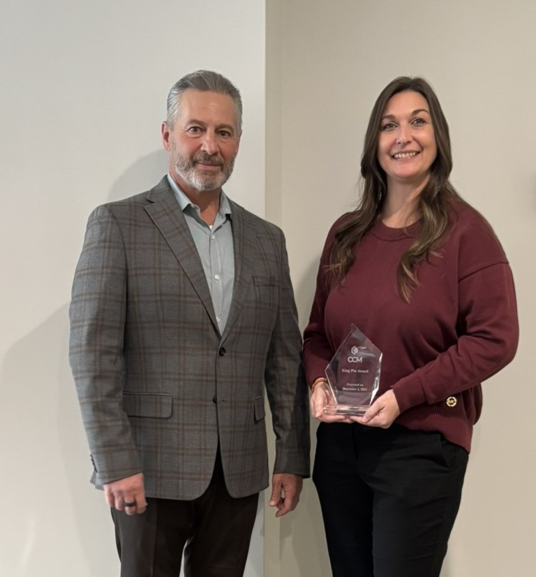 Paul Nazzaro, CEO presents Stacey Simpson, Director, Pool operations the 2025 King Pin Award.