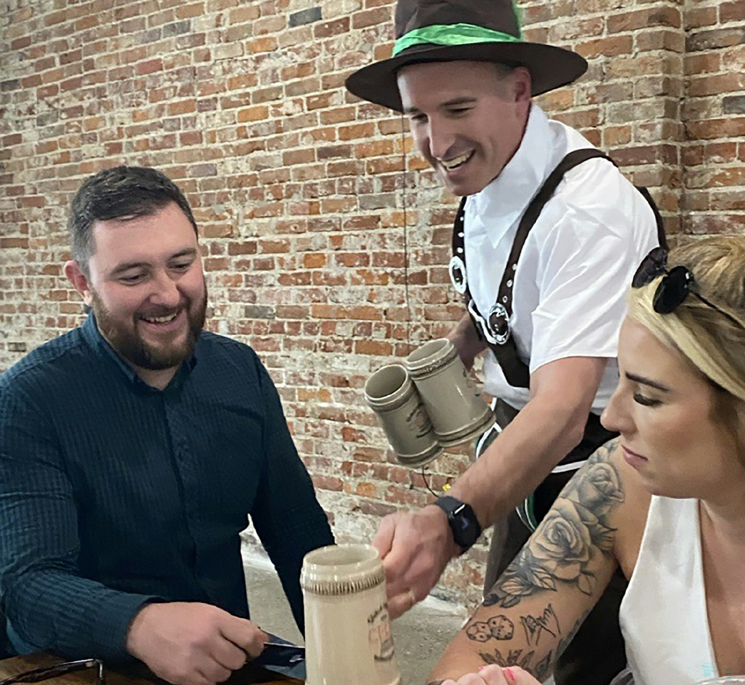 An executive leader wraps up a global offsite event in style, passing out steins and sharing laughs to end a great week.