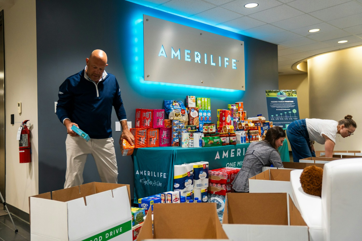 Leaders and team members organizing donations for our food drive in partnership with Feeding Tampa Bay