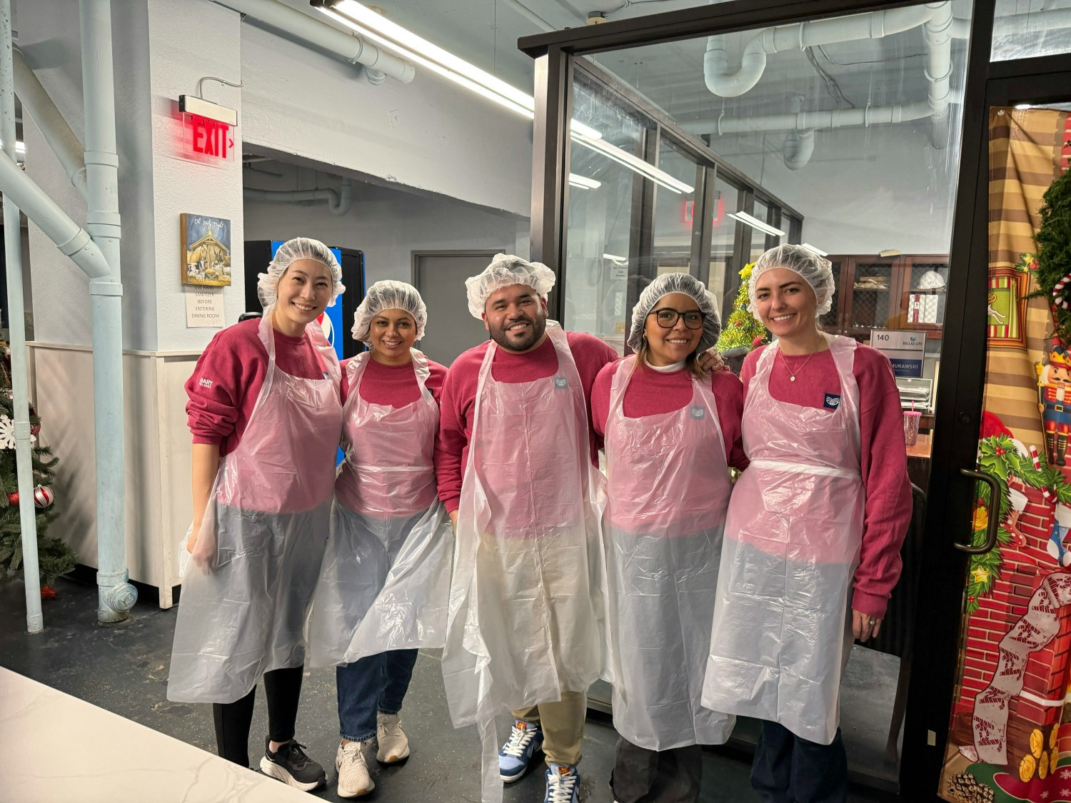The Canary Dallas team volunteering at Dallas Life homeless shelter—working together to give back to the community.