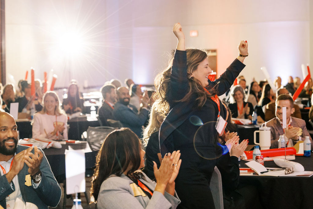 Fischer Homes associates cheer alongside their teammates, reflecting a culture of encouragement and shared celebration.