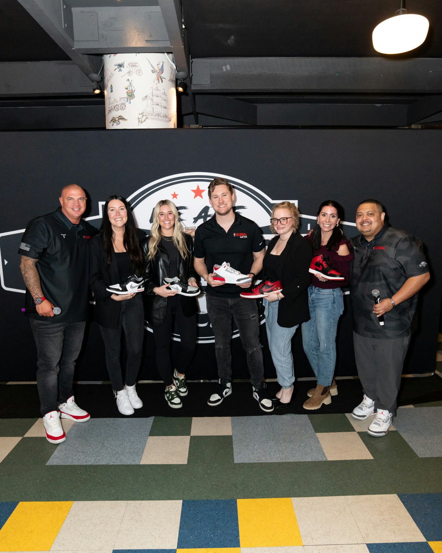 The Colossal Cares team receiving their Jordans for their efforts with our culture and charity ventures.