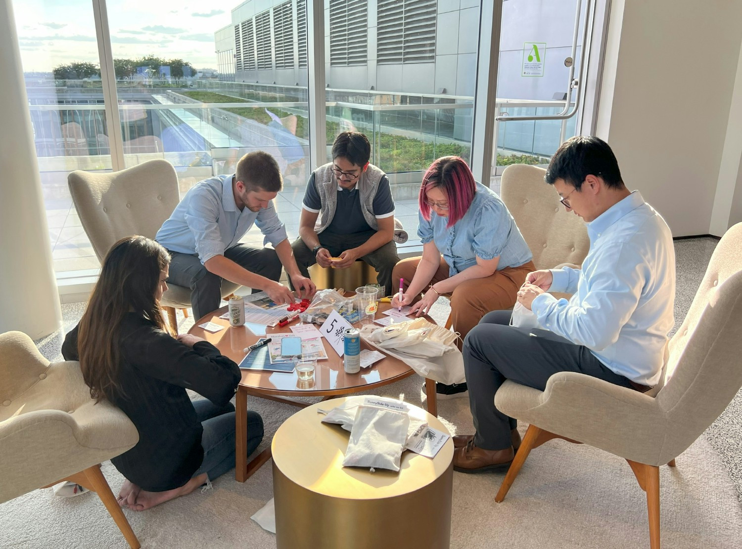 Employees assemble solar car kits to support STEM education, then build and race their own in a friendly competition.