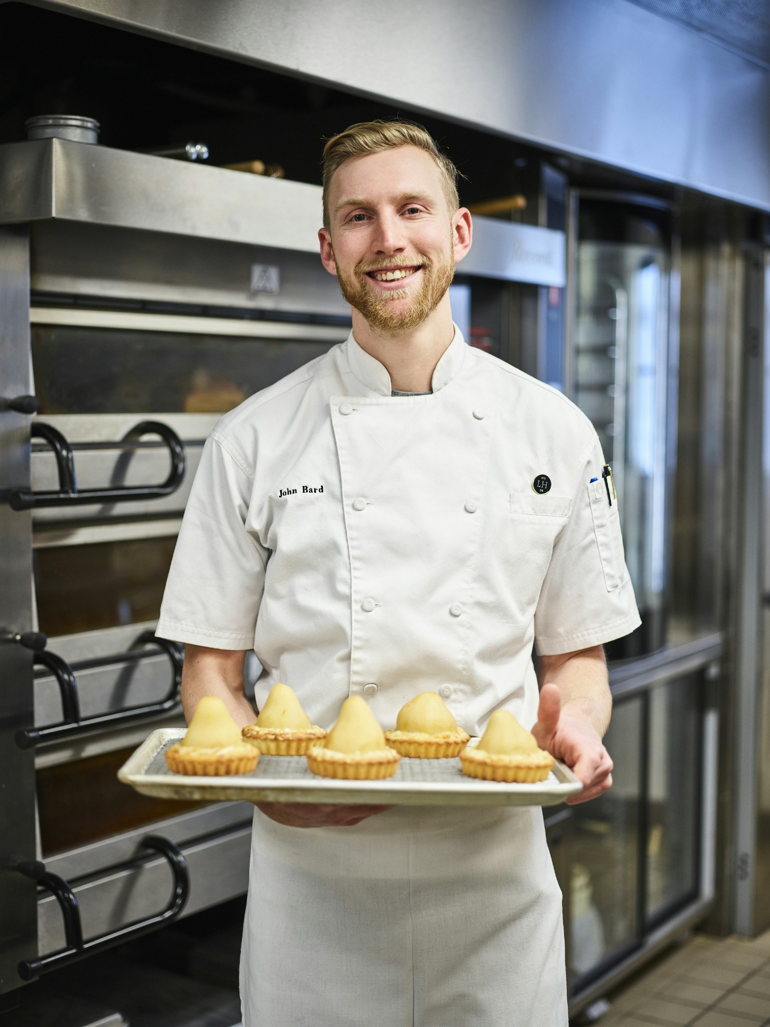 Executive Pastry Chef, John Bard, showcases his beautifully baked pear tarts fresh from the oven.
