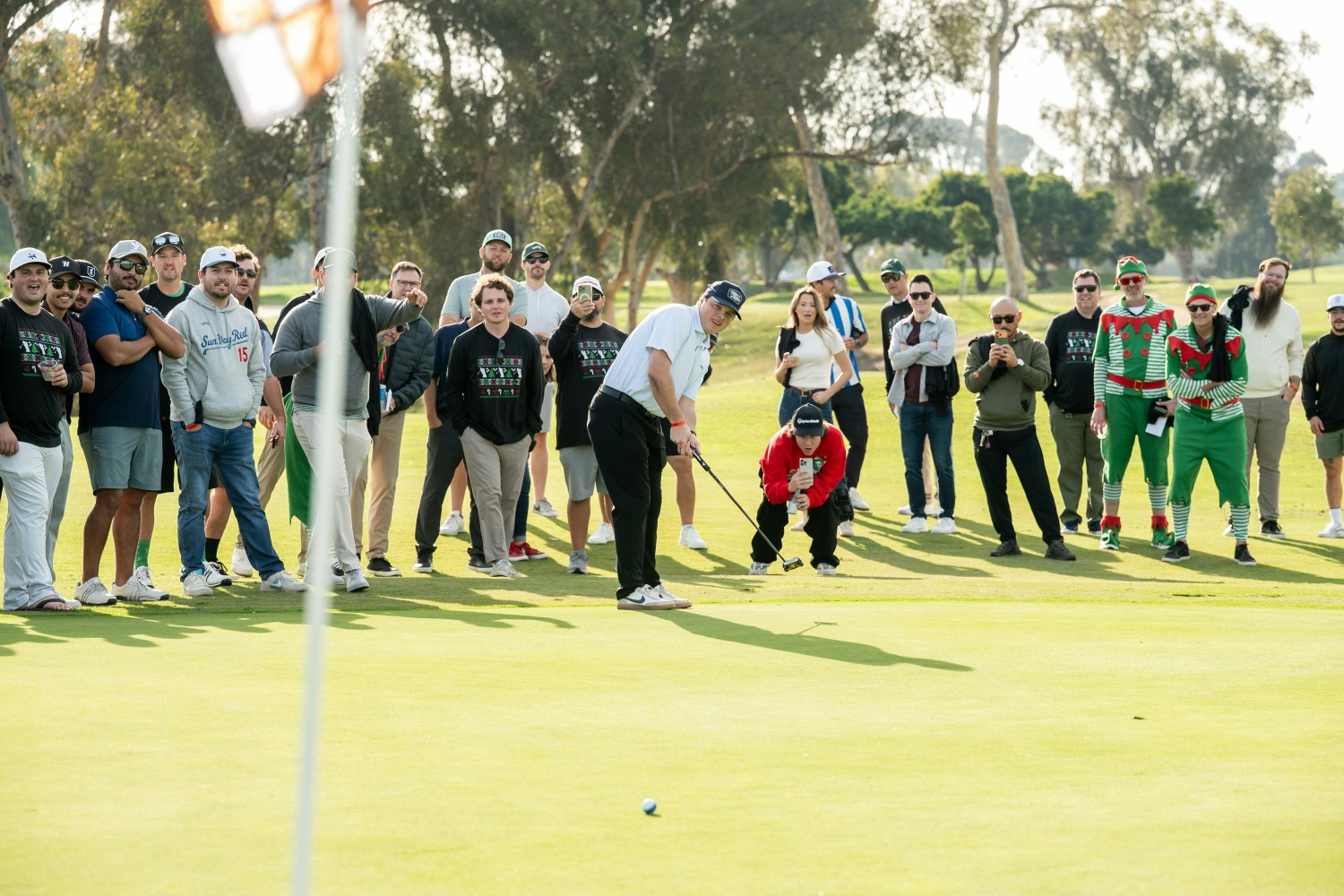 Work hard, play hard in action. No pressure. Just your entire team watching your putt at the holiday party.