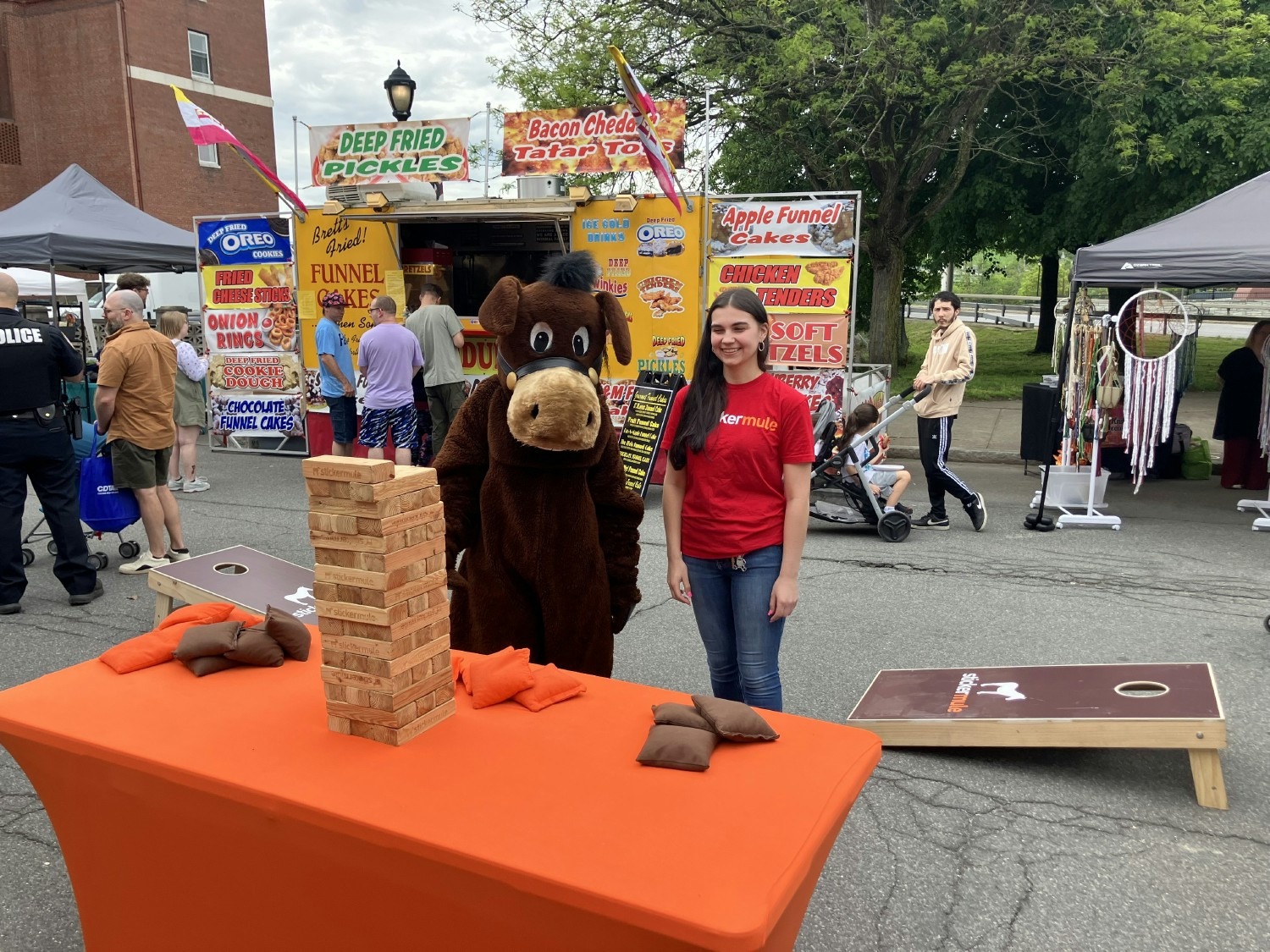 Sticker Mule mascot and team member fun at a community festival.