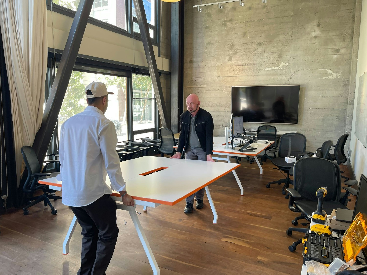 Scrappy startup days means everyone rolls up their sleeves, even when it comes to assembling desks and office space. 