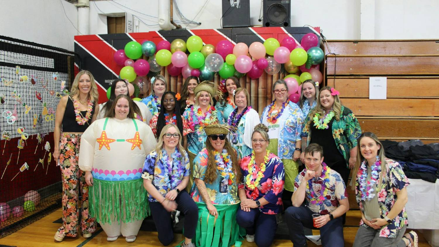 Staff are having a blast at the Annual Employee Event, participating in the Hawaiian-themed costume contest