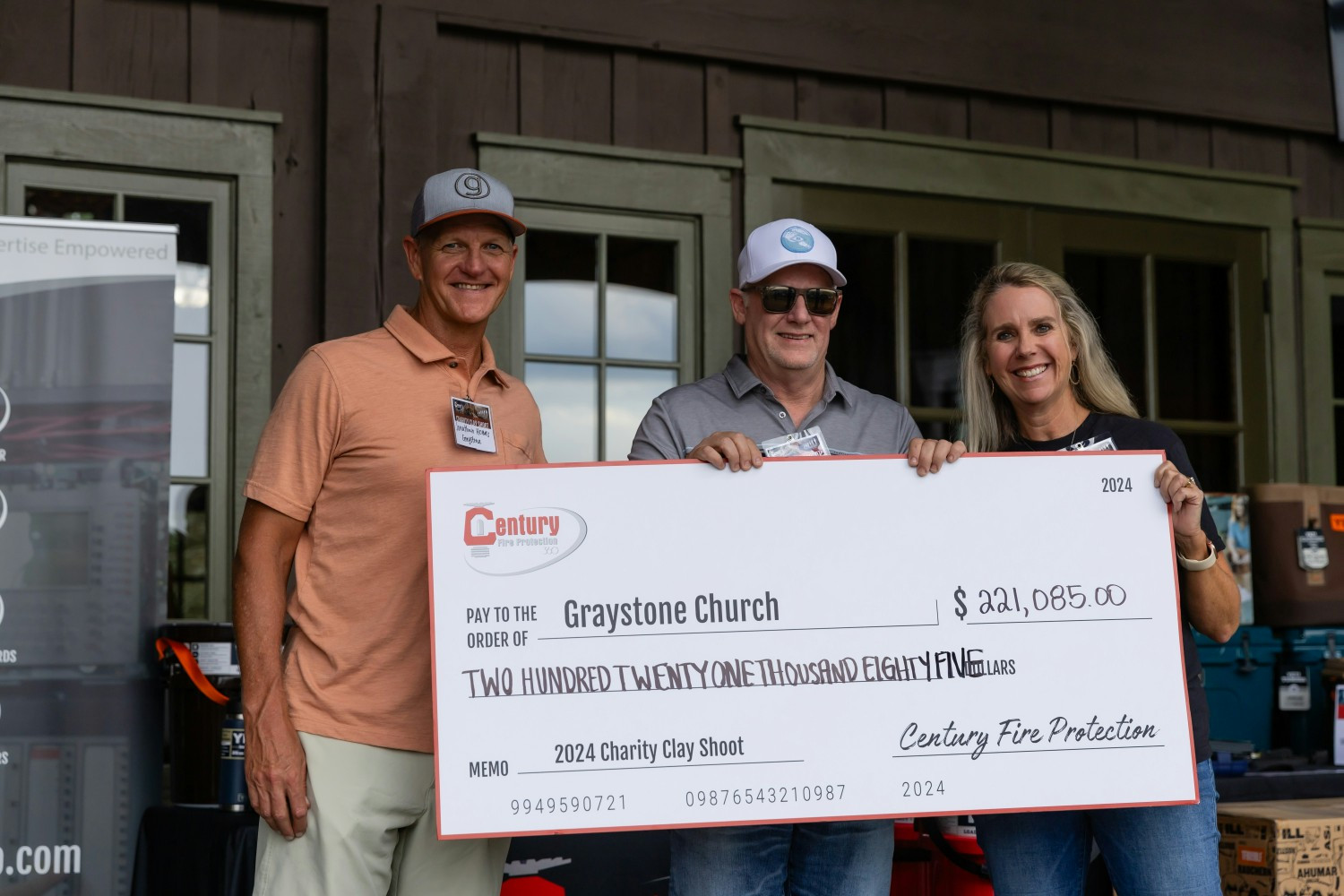 Founder Scott Tutterow presents a donation to Graystone Church, supporting foster kids through our Charity Clay Shoot.