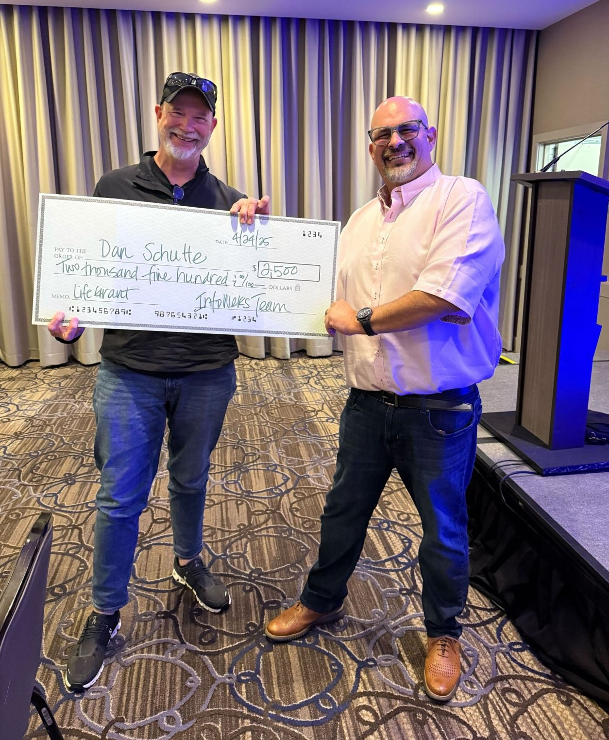 The Werks! winner, Dan, accepting his life grant via giant check!