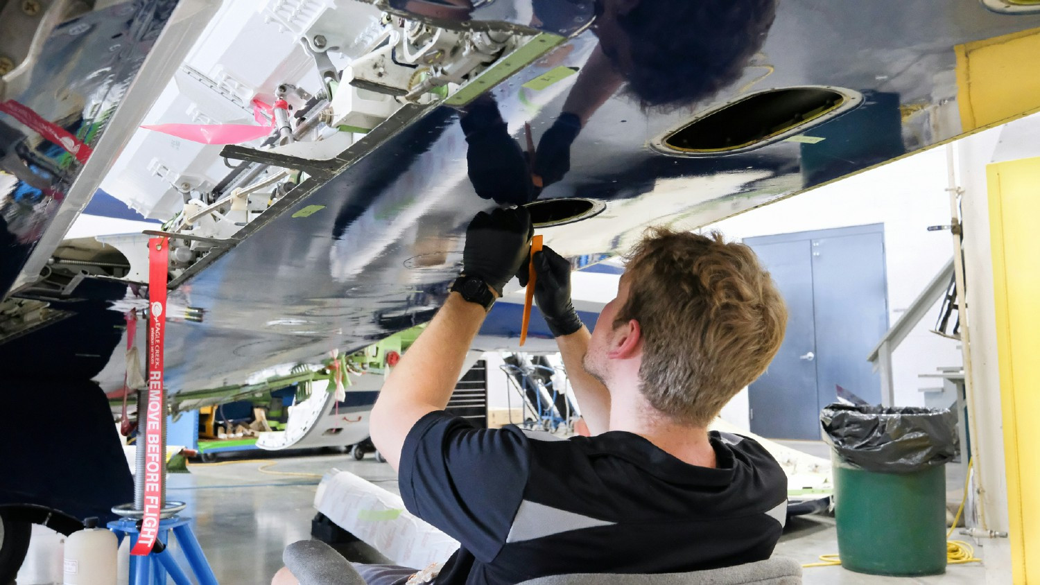 Maintenance team member ensures peak aircraft performance, showcasing technical expertise and dedication.
