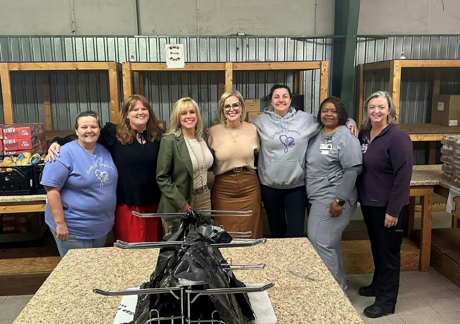 Staff volunteering at Back Pack Pals-a program that feeds children in local schools. 500 plus bags are packed weekly. 