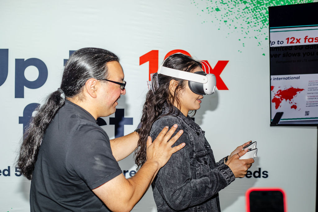 Innovation in action! Jose guiding Britt through a VR experience branded activation we built for a client event!