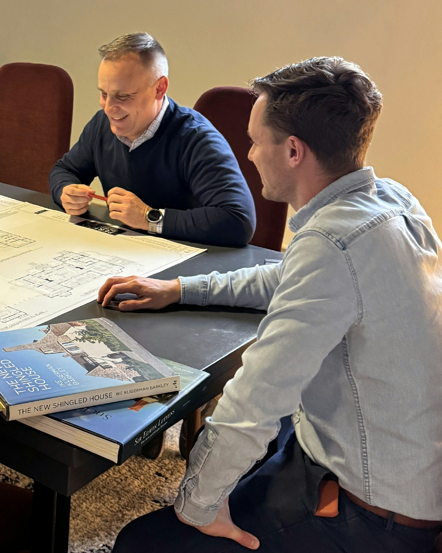 Our president and associate principal meet with a client to review plans.