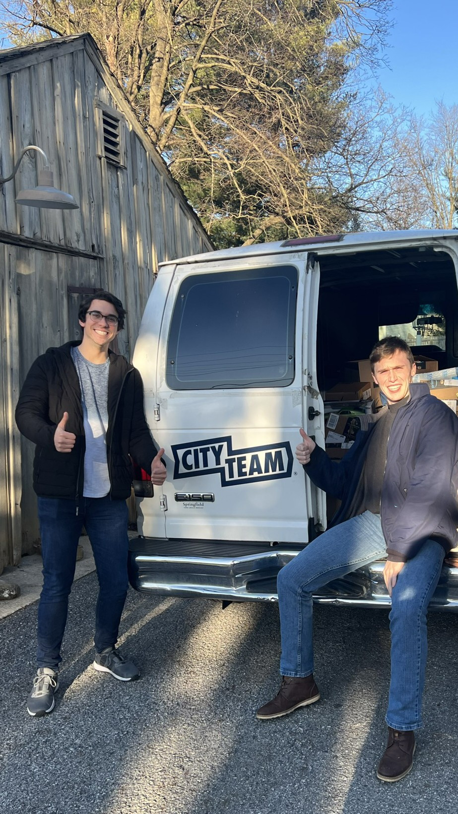 Two of our Drexel University interns after loading a van full of donations from our toy drive.