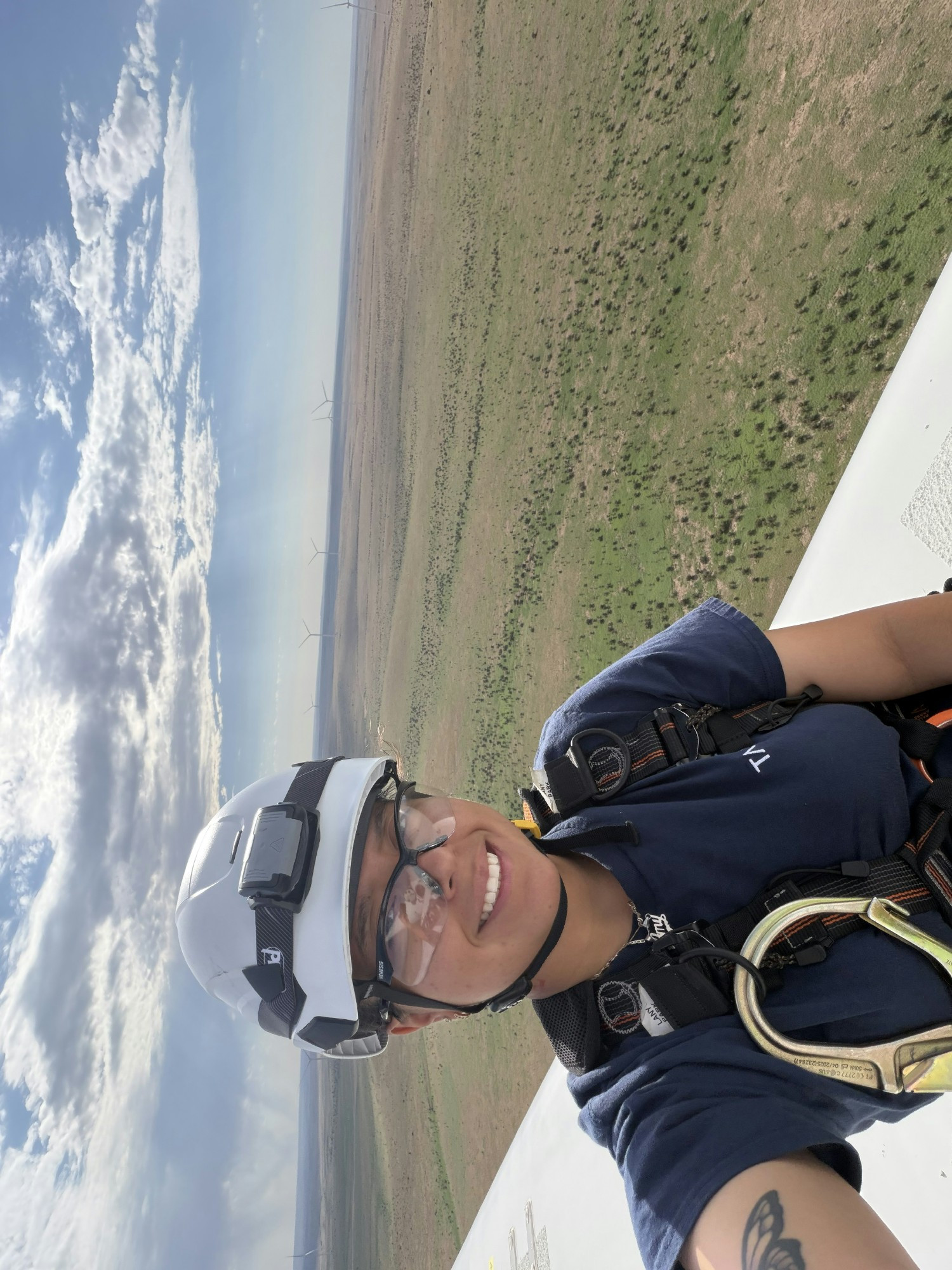 Employee up tower performing maintenance on a wind turbine.