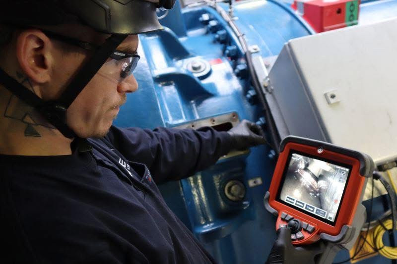An Inspections team member inspecting a double planetary gearbox.