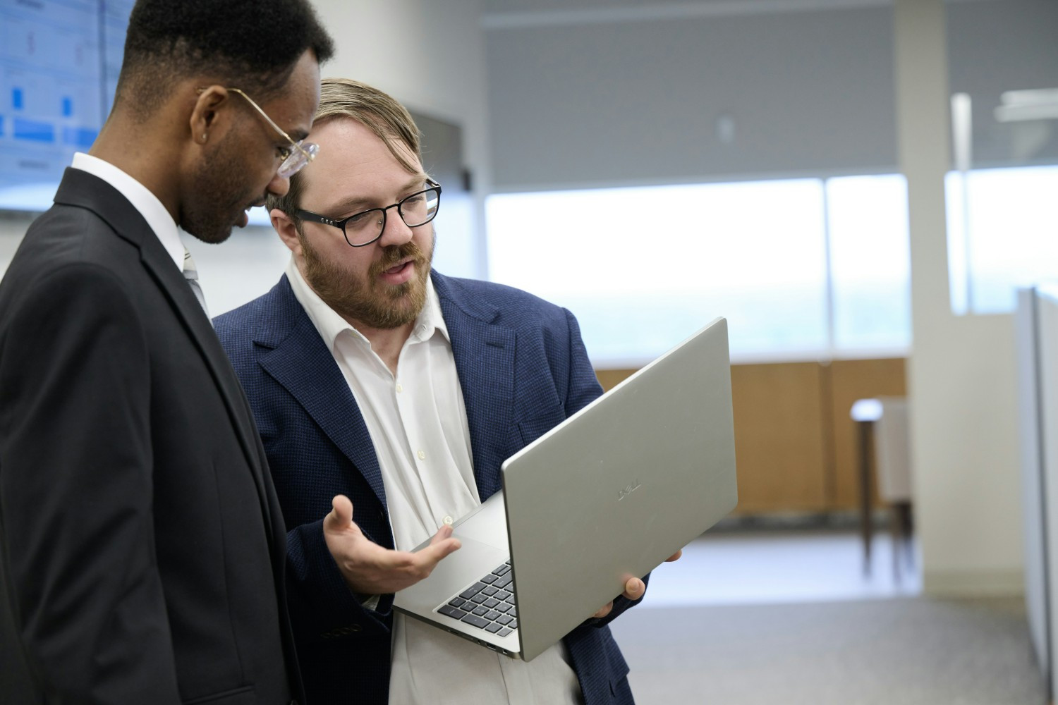 Christopher Fellows, Director of IT, works with Evan Shade, Digital Marketer, to strengthen digital presence.