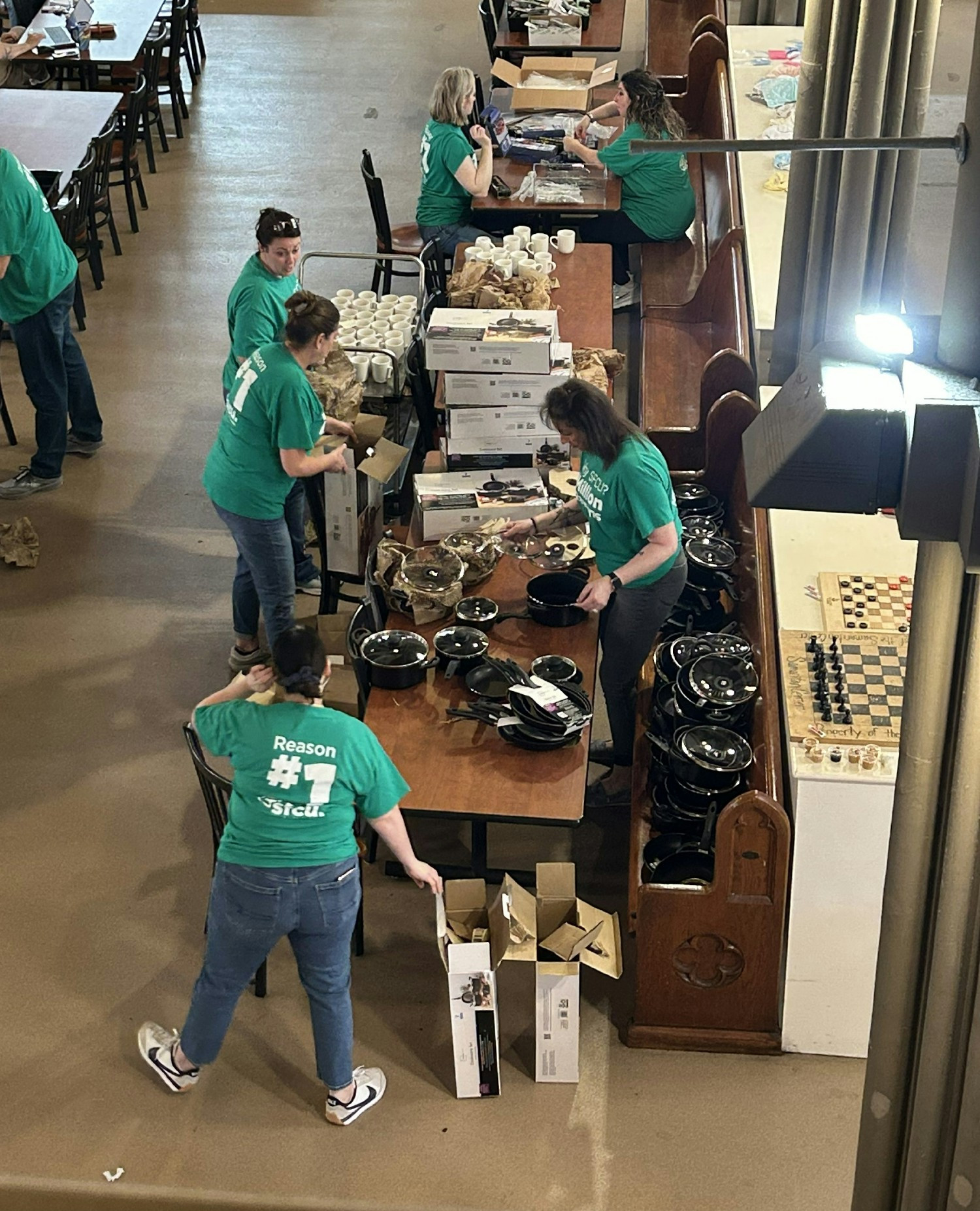 Employees volunteering to pack essential household kits for local families at the Samaritan Center in Syracuse, NY