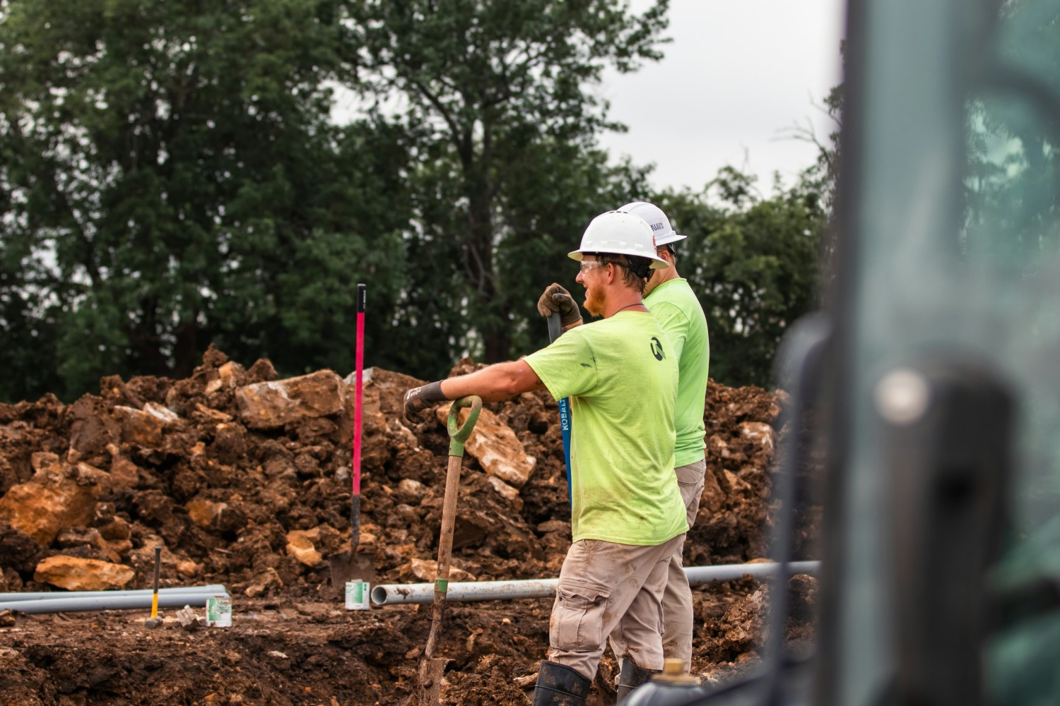 Two electricians overseeing an underground jobsite.