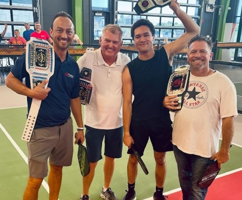 Two of Teague's partners and two employees at a company gathering.