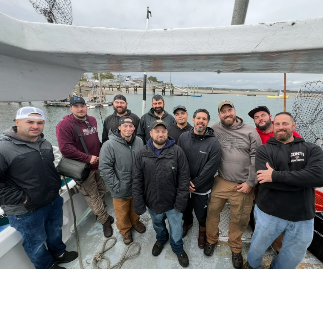 A group of team members on a charter boat for a team fishing excursion. 