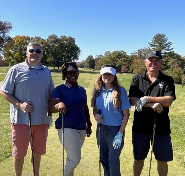 Our two leaders participating in a client golfing event.