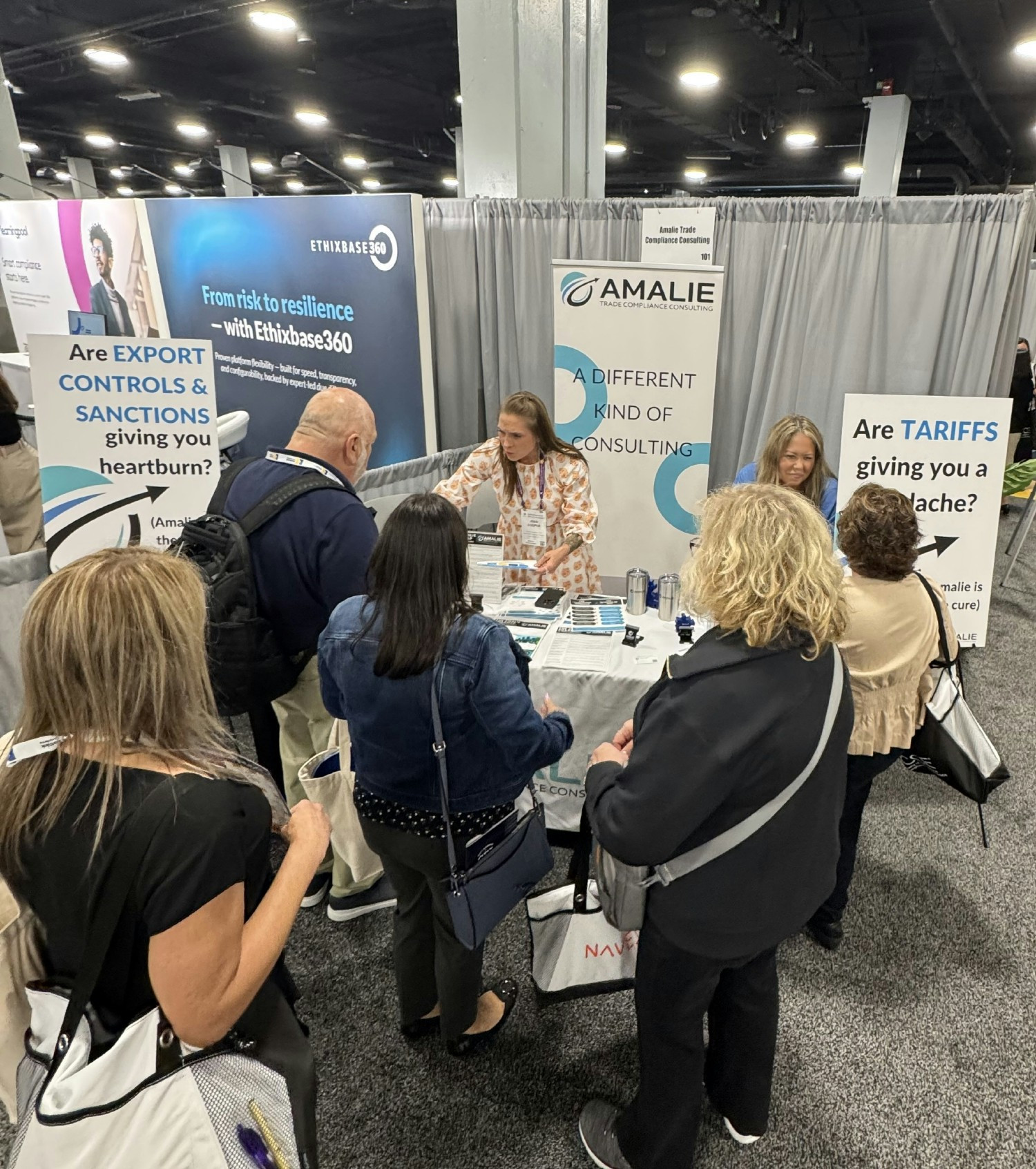 Jessi Cooper and Ellen Smith are busy discussing trade compliance and making connections at an industry event!