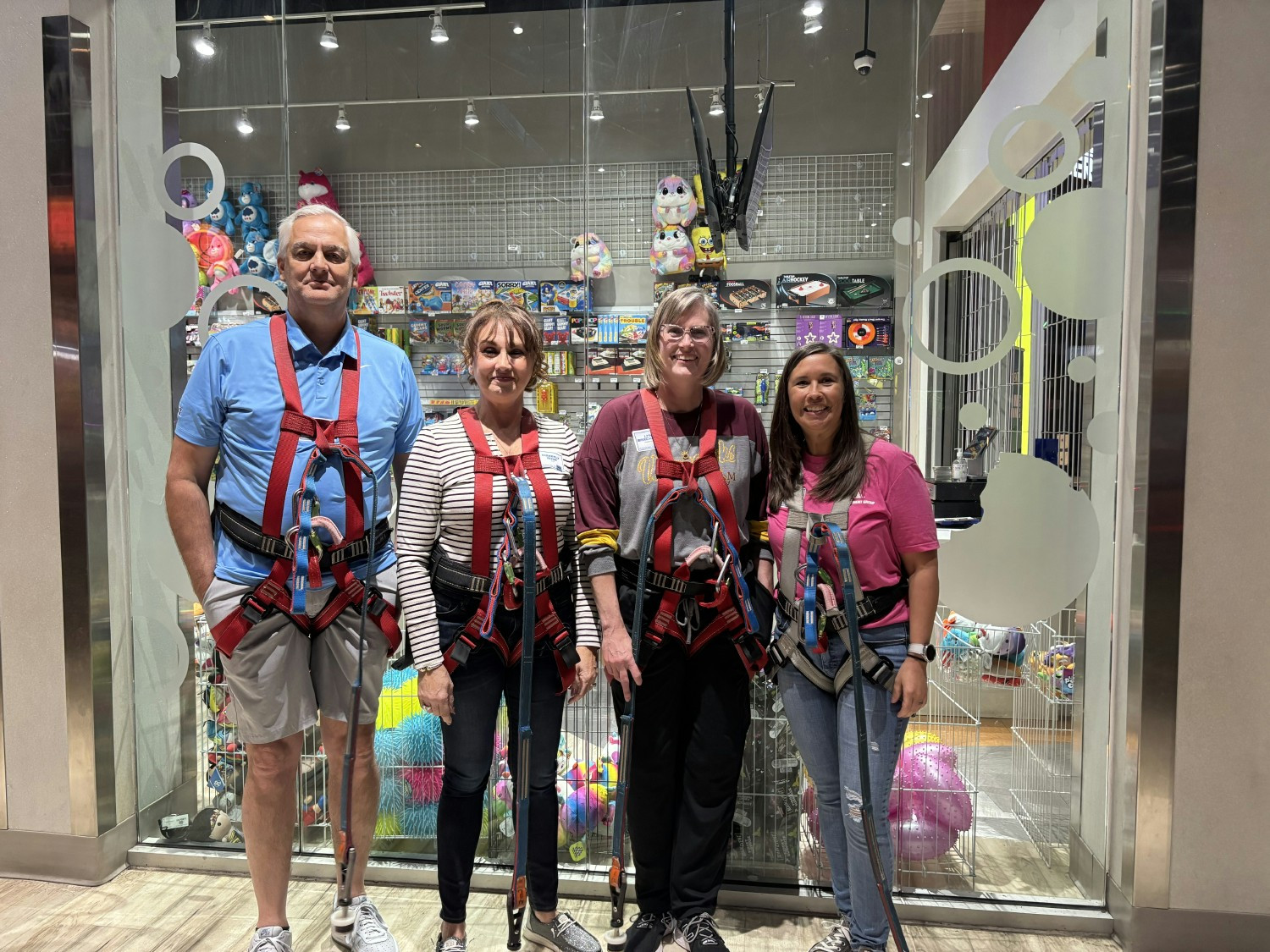 Employees getting ready for the ropes course at our day of fun at Main Event in Tulsa