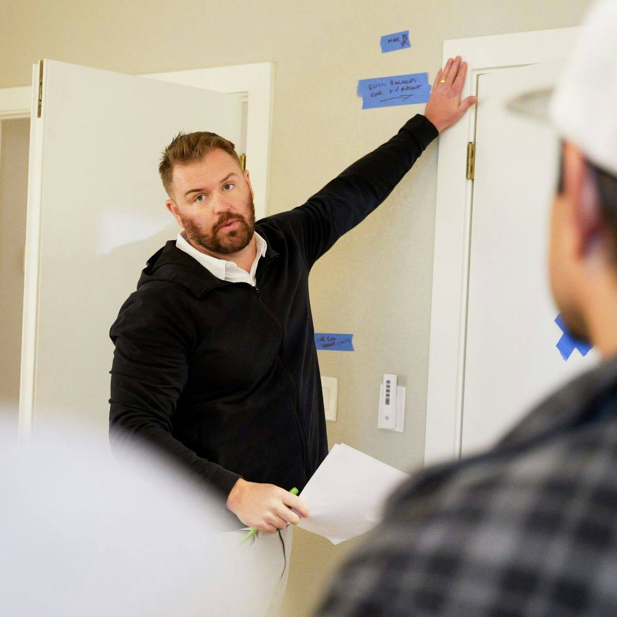 Project lead reviewing on-site details and talking through next steps with the team.