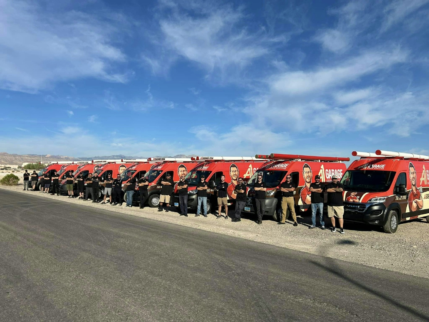 A1 Garage Door Service employees standing in front of A1-branded service trucks.