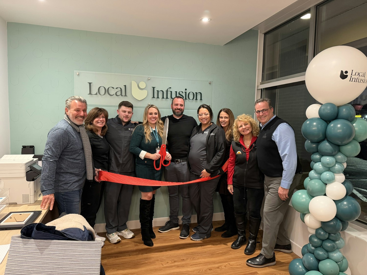 Local Infusion's team celebrates a new office opening.