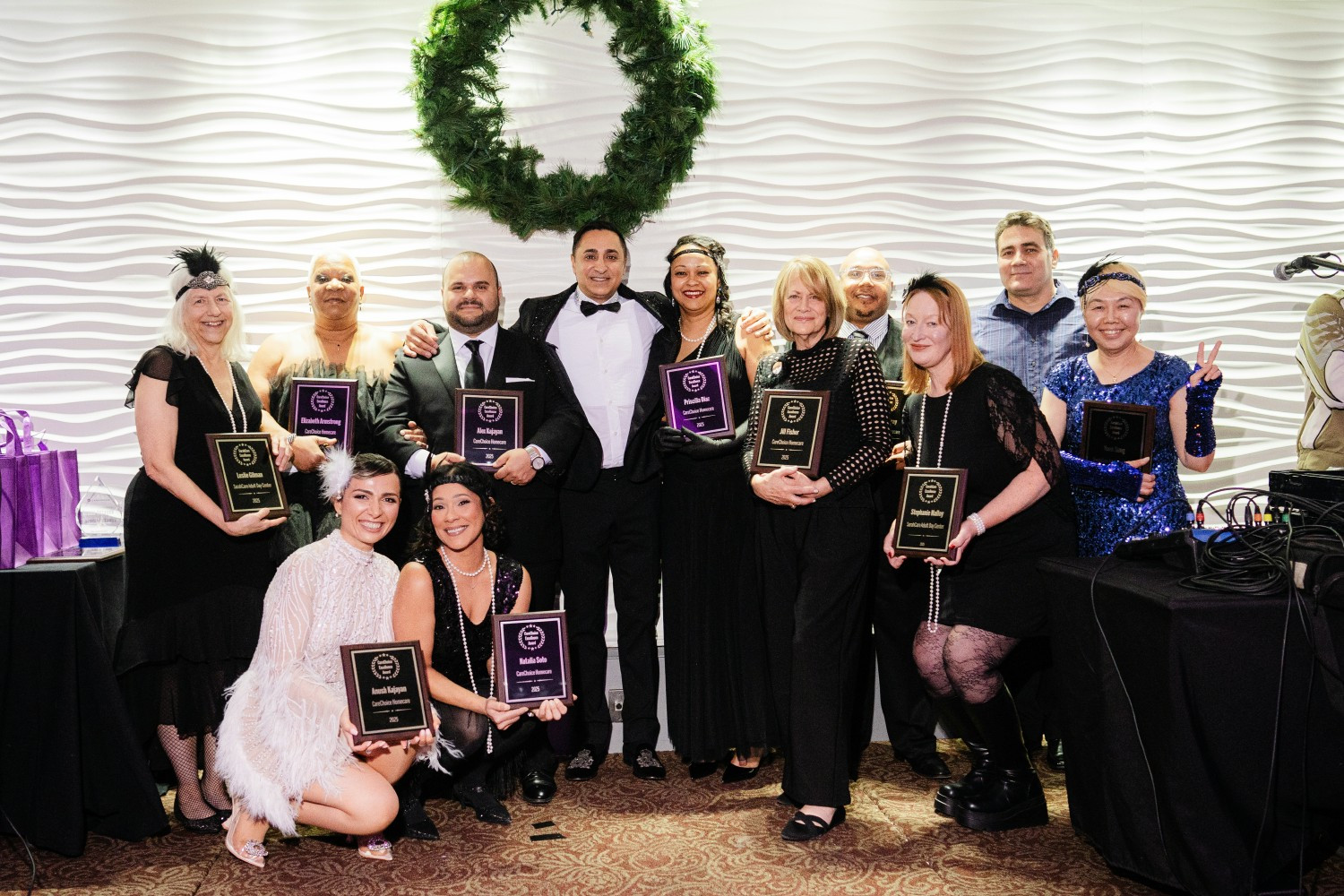 Our management team with their recognition plaques at our 2025 holiday party.