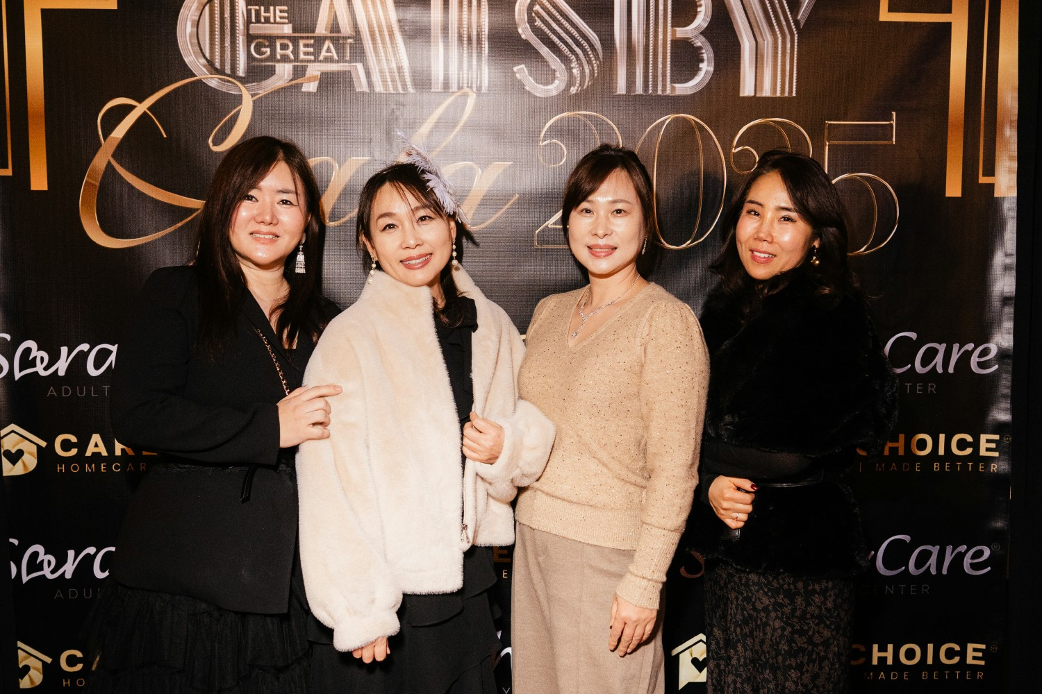 Employees posing on our red carpet at our holiday party.