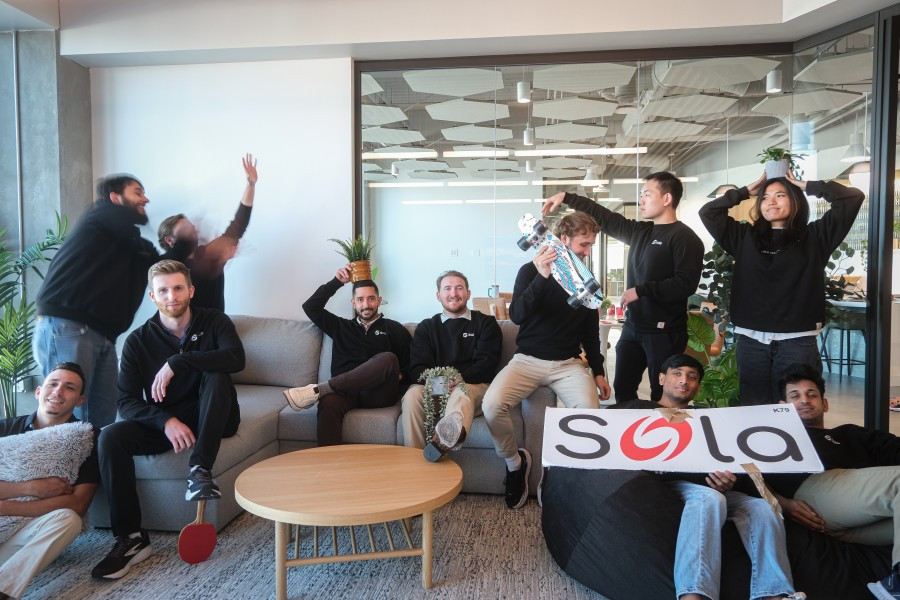 The Sola team celebrating a win together and bringing enthusiasm, humor, and team spirit into the workplace.