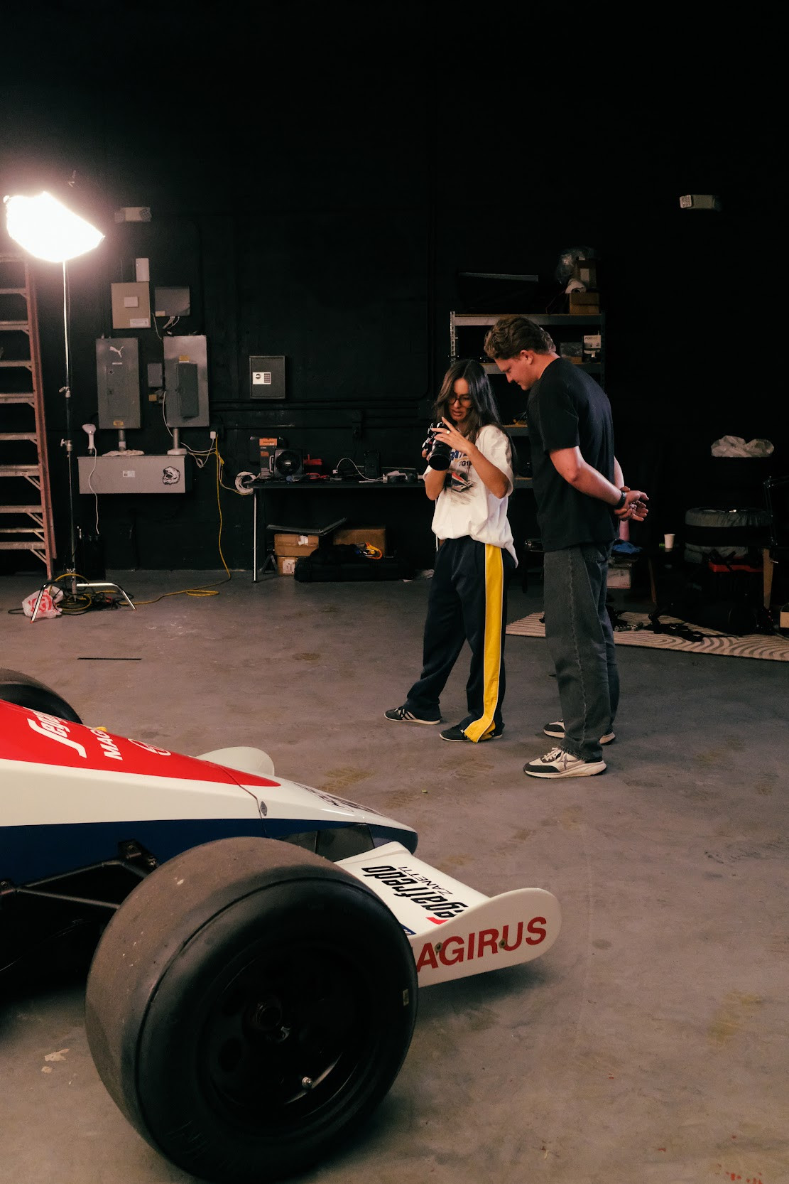 fashion show with new merch in front of the f1 car that inspired it