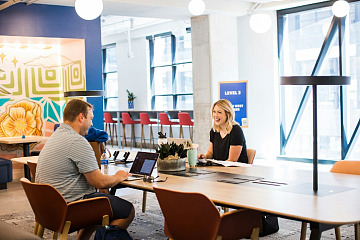 How Atlassian’s Peer Recognition Program Reinforces Its Culture Atlassian's peer recognition program is depicted with two coworkers having a conversation.