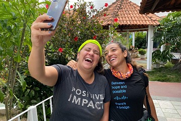 Two smiling Cisco employees take a selfie 