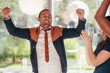 Employee recognition programs is depicted with an employee celebrating a workplace win! 
