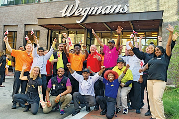 Employees at Wegmans supermarket take group photo.